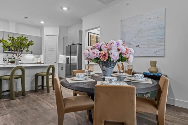 a dining room with furniture and wooden floor