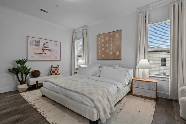 a bedroom with a large bed and a window