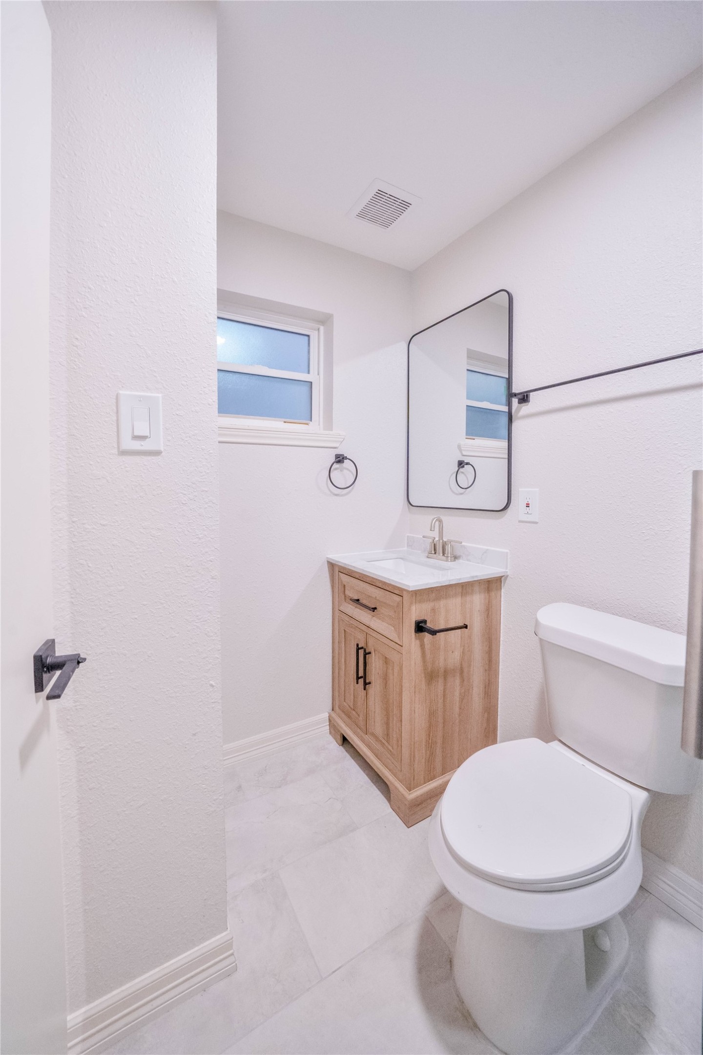 2703 Mason Street, Unit 2BD Houston, TX 77006 - Photo 13 of 19 a bathroom with a toilet sink vanity and mirror