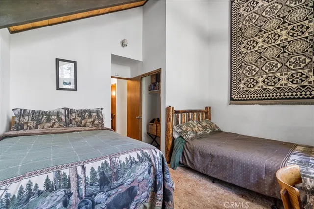 a bedroom with a large bed and a couch