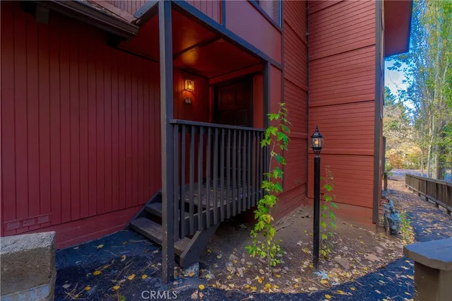 a view of a house with backyard and wooden fence