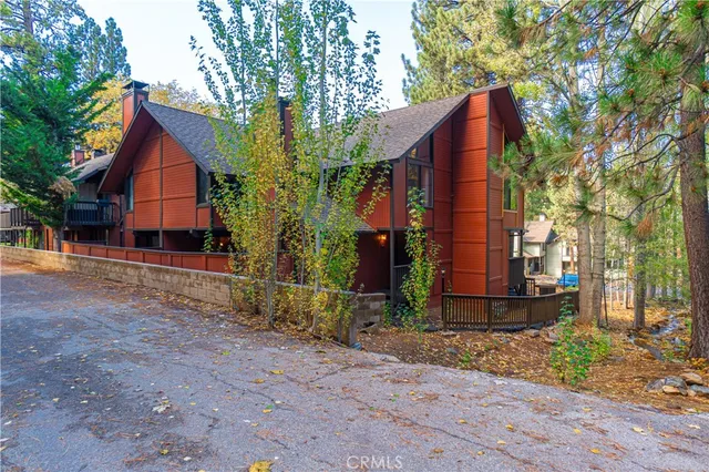 a view of barn house with a yard and large tree