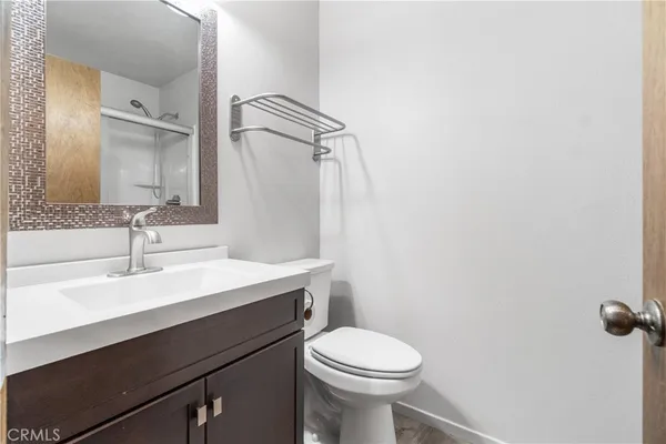 a bathroom with a sink a toilet a vanity and mirror