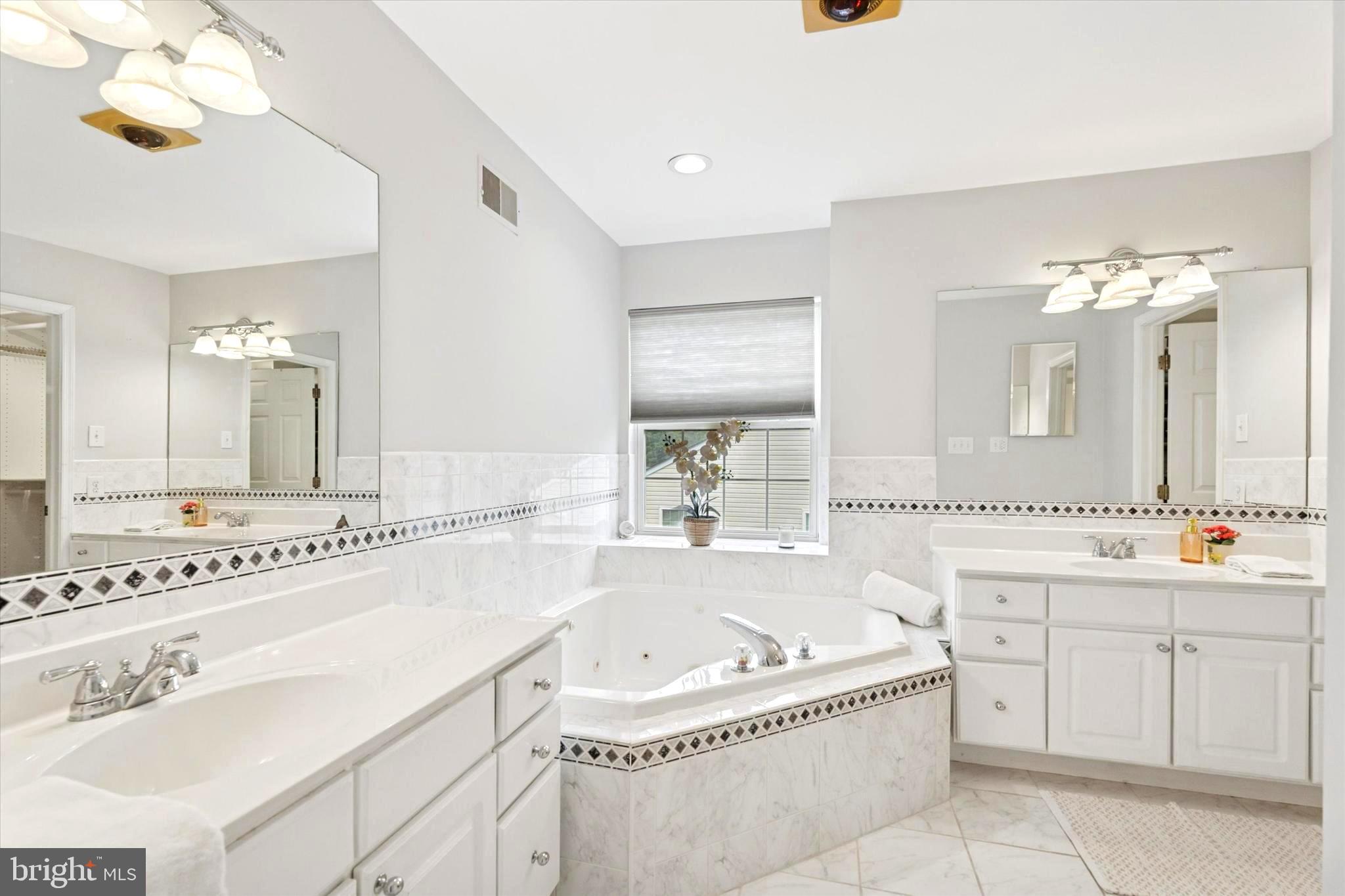 164 West Thompson Avenue Springfield, PA 19064 - Photo 13 of 28 a bathroom with a tub a double vanity sink and mirror