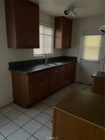 a kitchen with a sink and a stove top oven