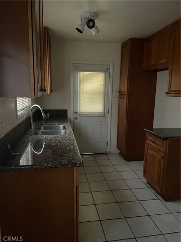 a kitchen with a sink appliances and cabinets