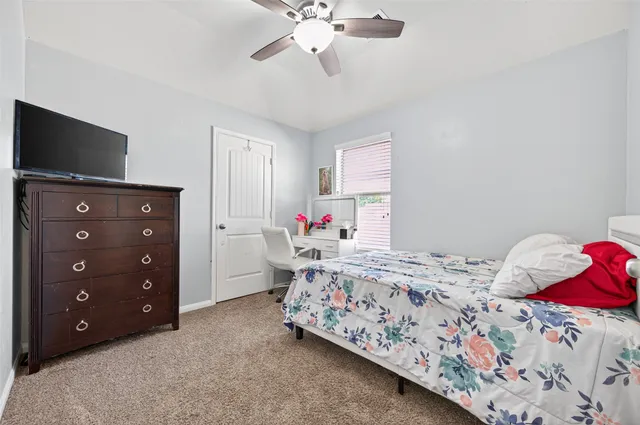 a bedroom with a bed and a tv