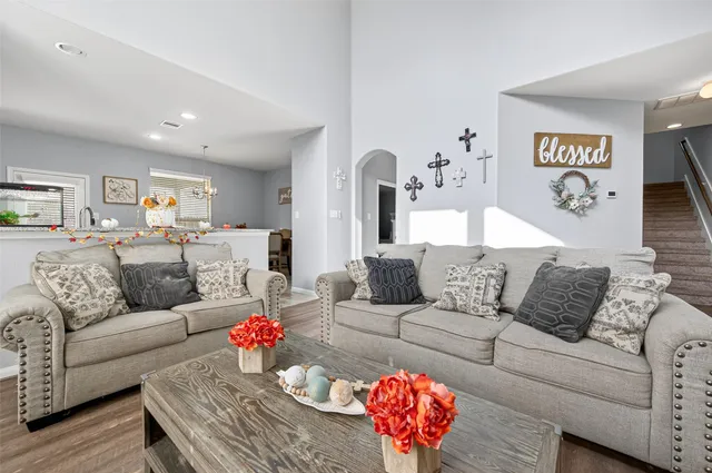 a living room with furniture and wooden floor