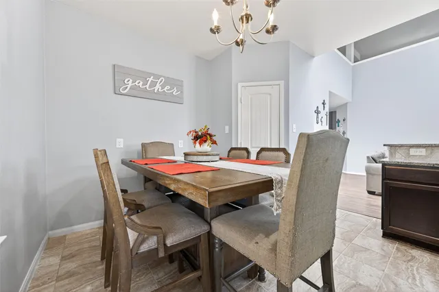 a dining room with furniture and chandelier