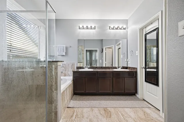 a bathroom with a bathtub and a sink