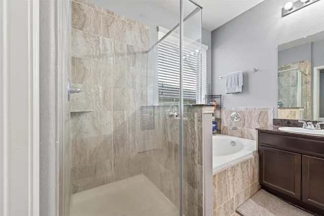 a bathroom with a tub sink and mirror