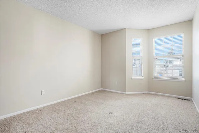 a view of a garage with wooden fence