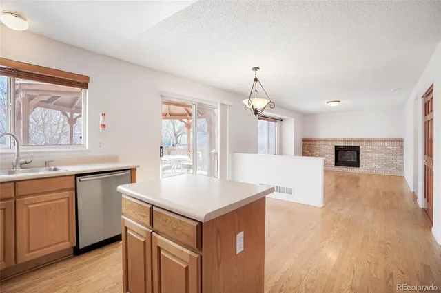 a view of kitchen with sink microwave and refrigerator