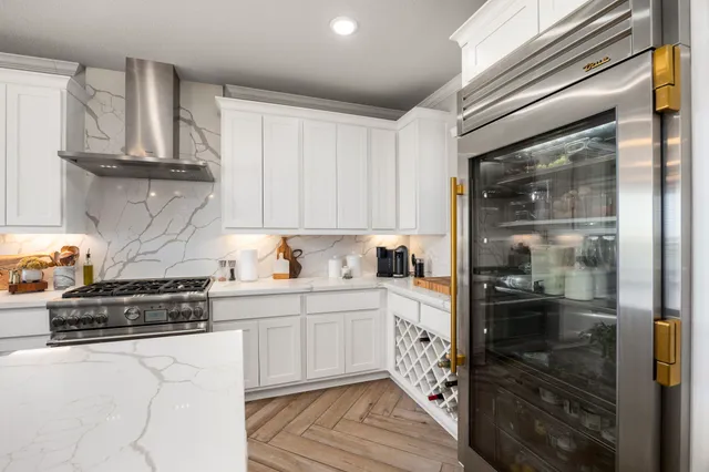 a kitchen with stainless steel appliances granite countertop a stove and a refrigerator