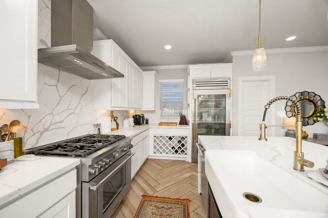 a kitchen with a stove a sink and a refrigerator