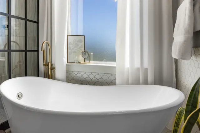 a view of walk in closet with clothes