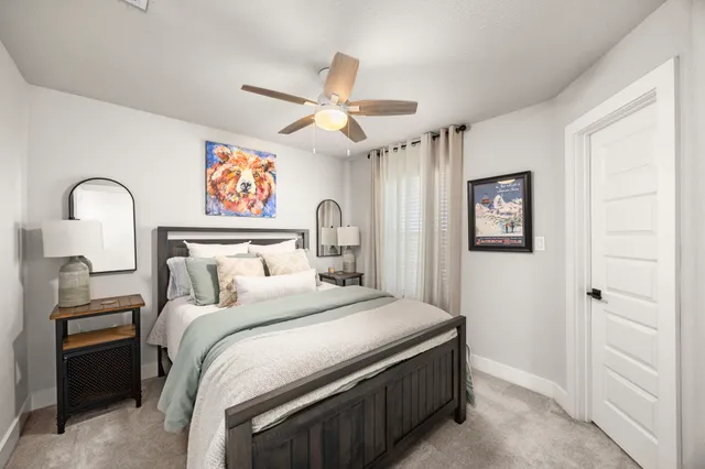 a bedroom with a bed and a chandelier