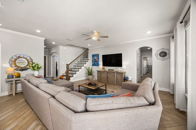 a living room with furniture and flat screen tv