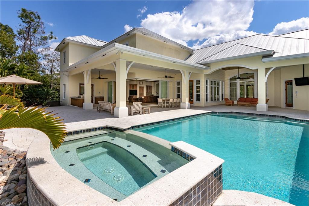 a view of a house with swimming pool and porch