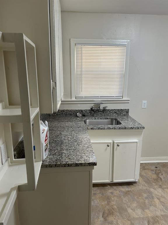 6318 Belgrade Avenue Dallas, TX 75227 - Photo 9 of 23 a bathroom with a granite countertop sink and a mirror