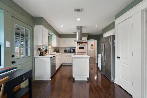 a kitchen with refrigerator and cabinets