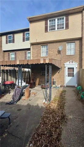 a view of a house with backyard porch and sitting area