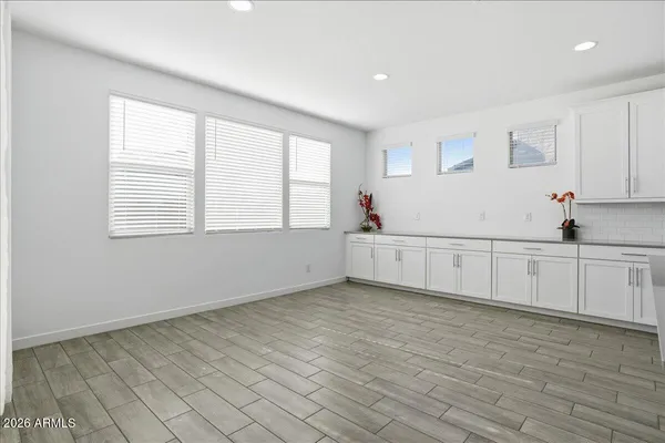 a large white kitchen with stainless steel appliances granite countertop a stove and a refrigerator