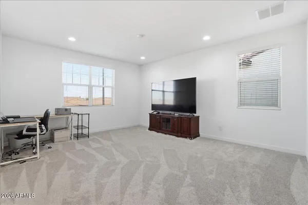 a bedroom with a bed chair and window