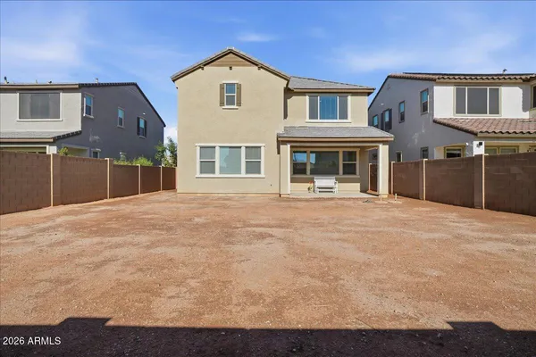 a front view of a house with a yard and lake view