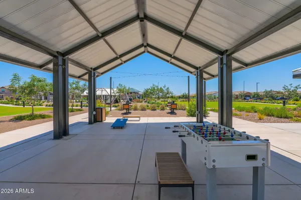 a view of a patio with a table and chairs under an umbrella