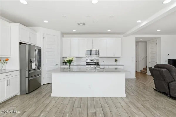 a kitchen with stainless steel appliances kitchen island granite countertop a sink and cabinets