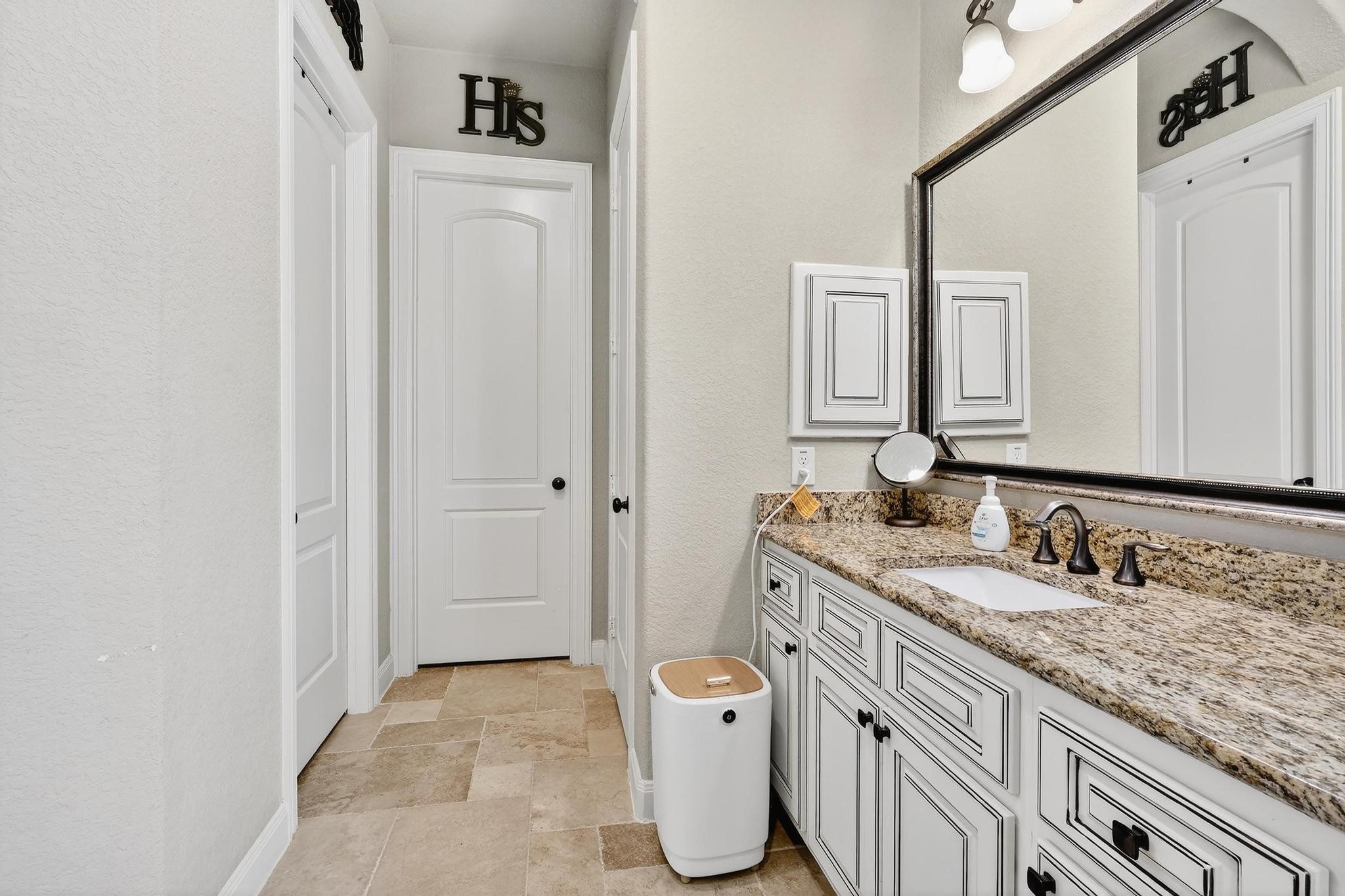 25803 Heritage Maple Drive Spring, TX 77389 - Photo 40 of 46 a bathroom with a granite countertop sink and a mirror