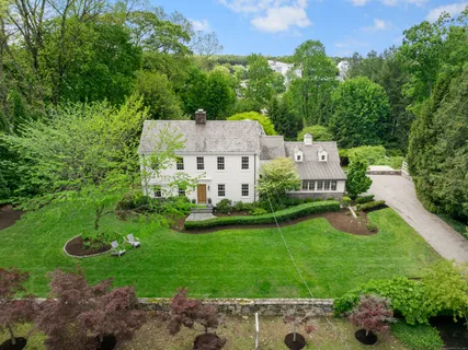an aerial view of a house with swimming pool garden and couple of relaxing chair
