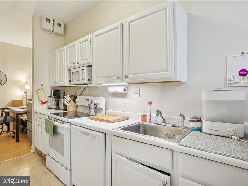 1615 Q Street Northwest, Unit 201 Washington, DC 20009 - Photo 13 of 20 a kitchen with stainless steel appliances granite countertop a sink a stove and cabinets