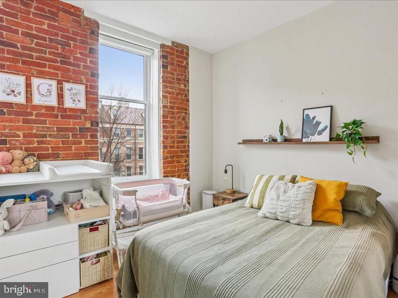 1615 Q Street Northwest, Unit 201 Washington, DC 20009 - Photo 17 of 20 a bedroom with a bed and a window