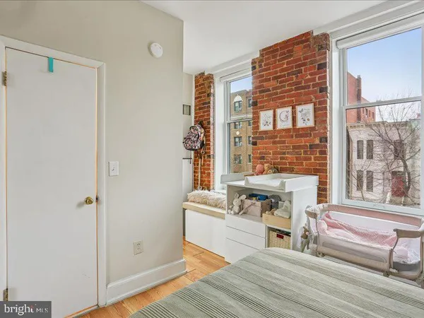 a living room with a table chairs and a refrigerator