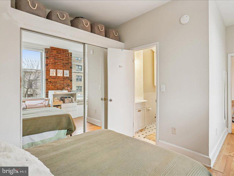 1615 Q Street Northwest, Unit 201 Washington, DC 20009 - Photo 19 of 20 a large bedroom with a large bed and a large window