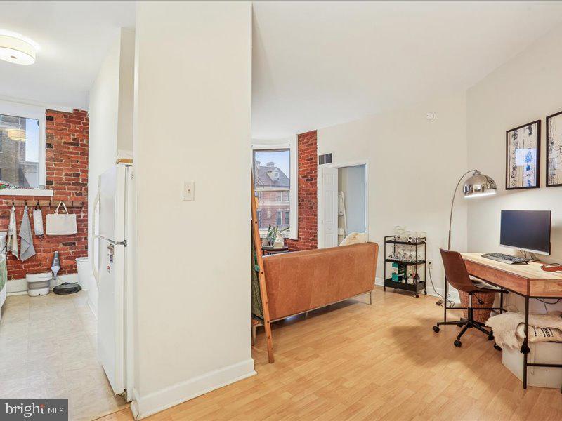 1615 Q Street Northwest, Unit 201 Washington, DC 20009 - Photo 4 of 20 a livingroom with workspace and a couch