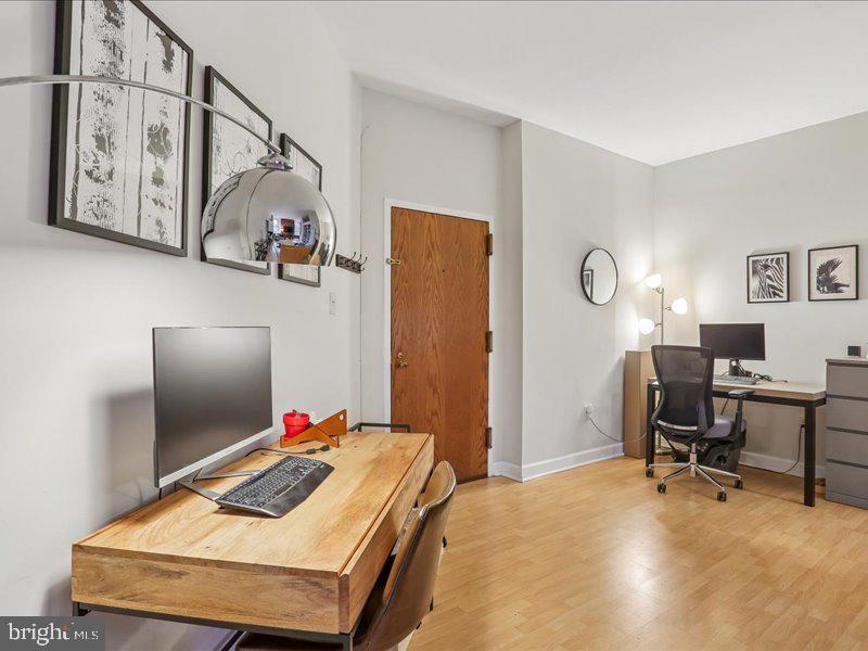 1615 Q Street Northwest, Unit 201 Washington, DC 20009 - Photo 7 of 20 a bedroom with a bed and a flat screen tv