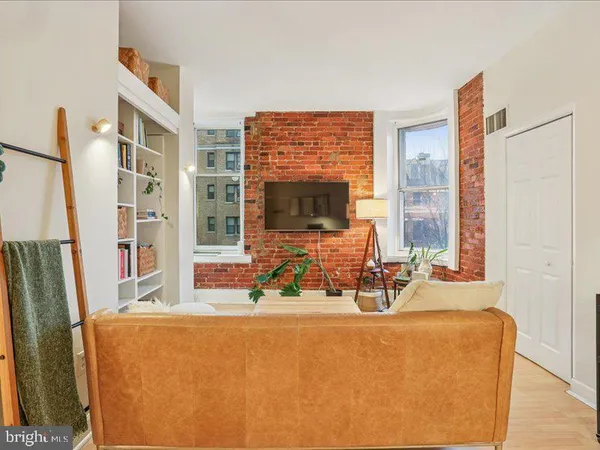 a view of a living room with furniture and a flat screen tv