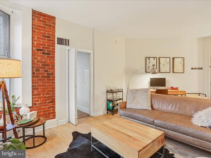 1615 Q Street Northwest, Unit 201 Washington, DC 20009 - Photo 10 of 20 a living room with furniture and a wooden floor