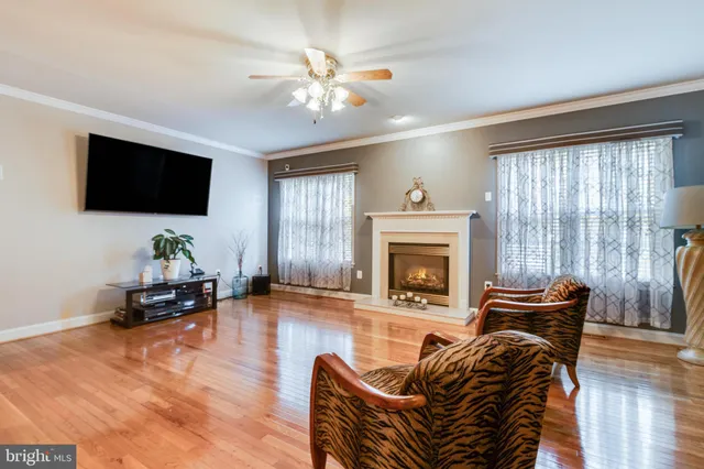 a dining room with furniture a chandelier and wooden floor