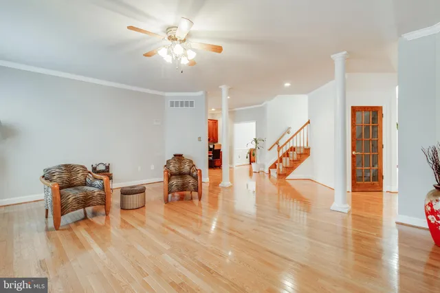 a kitchen with stainless steel appliances granite countertop a refrigerator a sink dishwasher a stove and a refrigerator with wooden floor