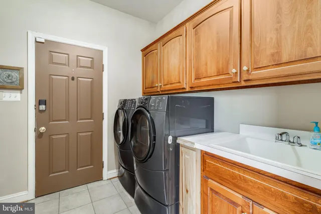 a kitchen with stainless steel appliances granite countertop wooden cabinets a sink dishwasher a stove and a refrigerator