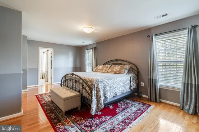a en suite bathroom with a tub and a large mirror next to a window