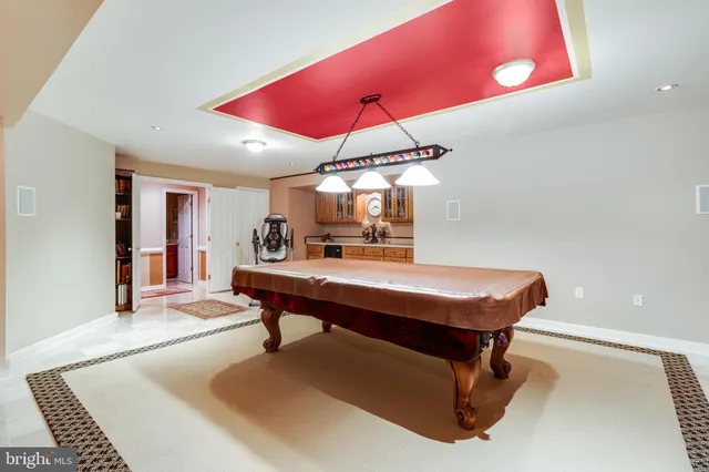 a view of a building with furniture and floor to ceiling window