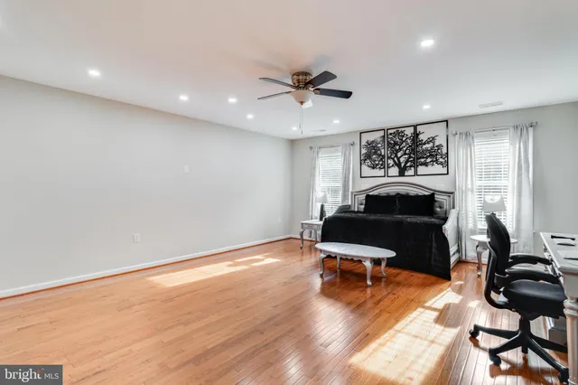 a kitchen with kitchen island granite countertop a stove oven and a refrigerator with cabinets