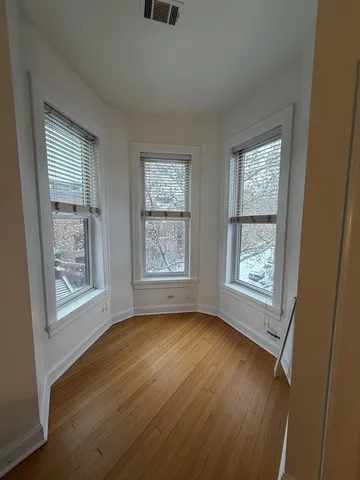 a view of room with window and hardwood floor