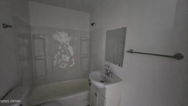 a bathroom with a shower and a sink