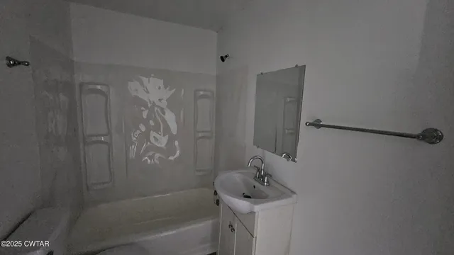 a bathroom with a shower and a sink